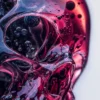 Close-up of a purple glass skull with intricate details of bubbles and liquid textures inside