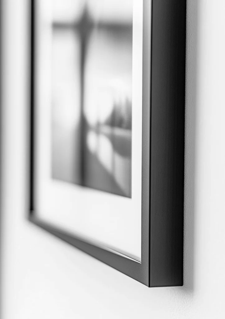 Black sleek frame showcased in black and white, used for our framed wall art